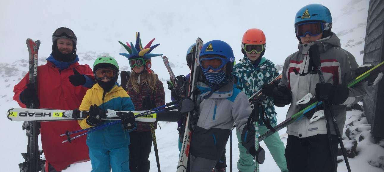 kids stand outside after ski lessons